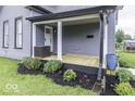 Relaxing front porch with a wood deck, stylish landscaping, and comfortable outdoor seating at 1201 Villa Ave, Indianapolis, IN 46203