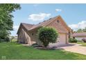 Side view of a brick and siding house with a well-kept lawn and mature landscaping at 1311 Old Hickory Dr, Greenwood, IN 46142