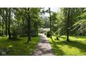 Scenic driveway winding through verdant trees, leading to a private residence with a peaceful ambiance at 1350 Inverness Farms Rd, Martinsville, IN 46151