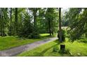 Long driveway leading through lush greenery to a secluded property, offering privacy and a serene setting at 1350 Inverness Farms Rd, Martinsville, IN 46151