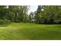 Expansive, well-maintained front lawn surrounded by mature trees, providing a picturesque and serene setting at 1350 Inverness Farms Rd, Martinsville, IN 46151