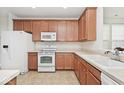 Functional kitchen features tiled floors, neutral countertops, and wood cabinetry at 15937 Marsala Dr, Fishers, IN 46037