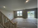 Bright open living space featuring large windows and patio door at 16465 Mount Logan Rd, Noblesville, IN 46060