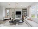 Bright living room with modern decor, lots of seating and a fireplace at 16465 Mount Logan Rd, Noblesville, IN 46060
