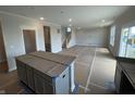 Unfinished open concept living room area with a kitchen island and stairs at 16465 Mount Logan Rd, Noblesville, IN 46060