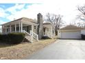 Lovely single-story home with detached garage, and inviting covered front porch, perfect for relaxing outdoors at 1739 Forest Dr, Indianapolis, IN 46227