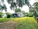 Grassy backyard with mature trees and a fence. A great space for outdoor activities and relaxation at 196 Bakemeyer St, Indianapolis, IN 46225