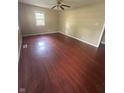Spacious living room featuring gleaming hardwood floors and a bright window, perfect for relaxing at 2180 N Irwin St, Indianapolis, IN 46219