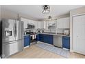 Stylish kitchen featuring white cabinets and stainless steel appliances and hardwood floors at 2580 Bluewood Way, Plainfield, IN 46168