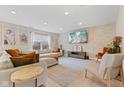 Spacious living room featuring a large sofa, exposed brick wall and recessed lighting at 2580 Bluewood Way, Plainfield, IN 46168