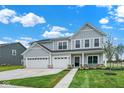 Charming two-story home boasts a three-car garage, well-manicured lawn, and inviting curb appeal at 2733 Bo W St, Plainfield, IN 46168
