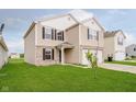 Attractive two-story home featuring a well-kept lawn and neutral siding at 2834 Wolfgang Dr, Indianapolis, IN 46239