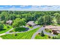 Aerial view of a secluded home surrounded by lush greenery and manicured lawns at 3528 E 116Th St, Carmel, IN 46033