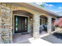 Inviting stone front porch with double doors and sitting area at 3528 E 116Th St, Carmel, IN 46033