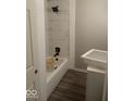 Cozy bathroom features a bathtub with a modern shower head and white marble tile at 3626 N Denny St, Indianapolis, IN 46218