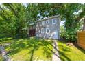 The grassy backyard features mature trees providing shade for outdoor activities and relaxation at 418 Eastern Ave, Indianapolis, IN 46201