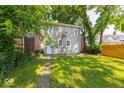 The backyard boasts a spacious lawn with mature trees, offering a serene outdoor setting at 418 Eastern Ave, Indianapolis, IN 46201