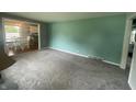 Inviting living room with neutral carpeting and view into adjacent room, bathed in natural light at 4363 Roosevelt Dr, Columbus, IN 47201