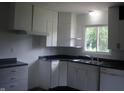 Functional kitchen with white cabinets and modern fixtures at 5 Tousley Ct, Indianapolis, IN 46224