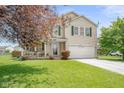 Inviting two-story home with a well-kept lawn, charming front porch, and attached two-car garage at 5631 N Peppereel Way, McCordsville, IN 46055