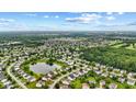 Beautiful aerial view of a neighborhood featuring well-maintained homes and a tranquil pond at 5637 Woodland Trace Blvd, Indianapolis, IN 46237