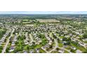 Expansive aerial view of a suburban community with lush green spaces and winding streets at 5637 Woodland Trace Blvd, Indianapolis, IN 46237