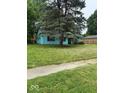Charming single-story home with vibrant blue siding and a well-maintained front yard, shaded by a mature tree at 5938 Price Ln, Indianapolis, IN 46254