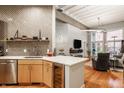 Open kitchen with stainless steel appliances and island that features marble countertops at 611 N Park Ave # 104, Indianapolis, IN 46204