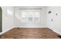 Bright living room with wood floors, white walls, and a large window at 614 N Drexel Ave, Indianapolis, IN 46201