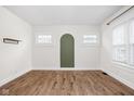 Cozy living room showcasing wood floors, white walls, and an arched wall detail at 614 N Drexel Ave, Indianapolis, IN 46201