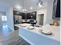 Stylish kitchen featuring stainless steel appliances, quartz countertops, and a breakfast bar at 6350 Stallion Way, Indianapolis, IN 46260