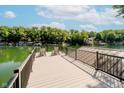 Scenic lake view from a private wooden dock with metal railings, perfect for relaxing or fishing at 6492 Osprey Dr, Nineveh, IN 46164