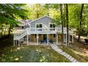 Beautiful two-story home featuring a stone foundation, white deck, and staircase leading to the yard at 6492 Osprey Dr, Nineveh, IN 46164