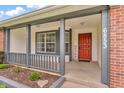 Inviting front porch with a red front door and decorative welcome mat provides curb appeal at 6853 Kellum Dr, Indianapolis, IN 46221