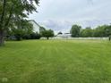 Expansive lush, green yard enclosed by a white fence, perfect for outdoor activities and privacy at 7195 W 700 N, Fairland, IN 46126