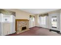 Inviting living room features a brick fireplace, soft carpet, and lots of natural light at 753 Walnut St, Franklin, IN 46131