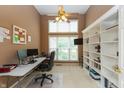 Bright office with built-in bookshelves, a ceiling fan, and large windows at 7818 Fawnwood Dr, Indianapolis, IN 46278