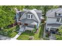 Charming home with a well-manicured lawn and a real estate sign at 909 N Parker Ave, Indianapolis, IN 46201