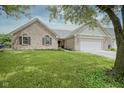 Charming single-Gathering home featuring a two-car garage, brick accents, and well-maintained landscaping at 11418 Geist Valley Dr, Indianapolis, IN 46236