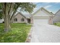 Charming single-Gathering home featuring a two-car garage, brick accents, and well-maintained landscaping at 11418 Geist Valley Dr, Indianapolis, IN 46236