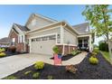 Inviting home with an attached two-car garage, well-landscaped yard, and a welcoming entrance at 11429 Lottie Cir, Noblesville, IN 46060