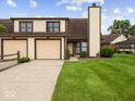 Inviting townhome with attached two-car garage and well-manicured lawn at 1205 Cypress Dr, Shelbyville, IN 46176