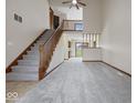 Open living room showcasing staircase and second story overlook at 1205 Cypress Dr, Shelbyville, IN 46176