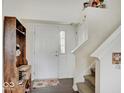 Inviting foyer with hardwood floors, stairs, a hall tree, and a charming rug at 1255 Crabapple Rd, Franklin, IN 46131