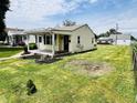 Quaint single-story home with tidy landscaping, featuring a covered entryway and cozy curb appeal at 128 E 36Th St, Anderson, IN 46013