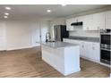 Modern kitchen features white cabinets, stainless appliances, granite countertops, and a stylish island, perfect for culinary enthusiasts at 1429 Udell St, Indianapolis, IN 46208