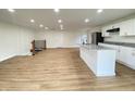 Bright and open living space with hardwood floors, a modern island kitchen, and plenty of natural light at 1429 Udell St, Indianapolis, IN 46208