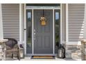 Close up of the front door of the home, complete with stylish decor and a secure entrance at 1497 Maple Ridge Ct, Columbus, IN 47201