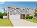 Two-story home with an attached two-car garage and well-maintained landscaping at 1739 Wedgewood Pl, Avon, IN 46123