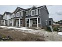 New two story townhome with horizontal siding, covered entry, and concrete sidewalk at 19541 Grassy Branch Rd, Westfield, IN 46074